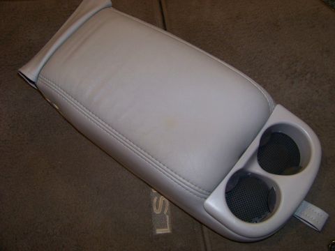 1999 Mercury Grand Marquis - Car armrest with integrated dual cupholders, likely from a sedan's center console.