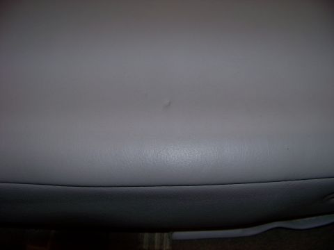 1999 Mercury Grand Marquis - Close-up of a gray leather armrest, part of the interior of a 1999 Mercury Grand Marquis.