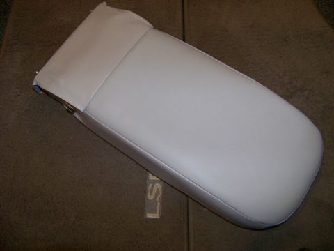1999 Mercury Grand Marquis - A light beige armrest is shown against a brown carpeted surface.