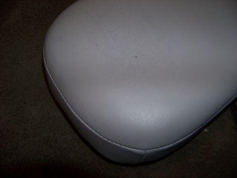 1999 Mercury Grand Marquis - Close-up of a car's interior armrest, showing its texture and stitching detail against the carpet.