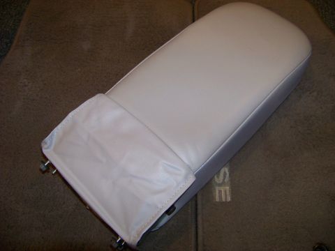 1999 Mercury Grand Marquis - A car armrest is shown from a top-down perspective, resting on a floor mat.