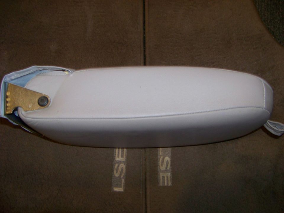 White leather armrest with visible mounting bracket and "LSE" embossed on seat fabric