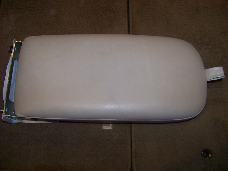 beige car armrest with metal bracket