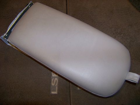 1999 Mercury Grand Marquis - A car armrest is shown against a textured fabric background with embossed lettering.