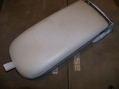 1999 Mercury Grand Marquis - A single beige armrest is shown from a top-down perspective, with visible stitching along its edges.