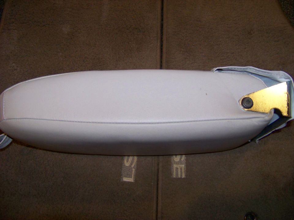 Light gray armrest with gold mounting bracket