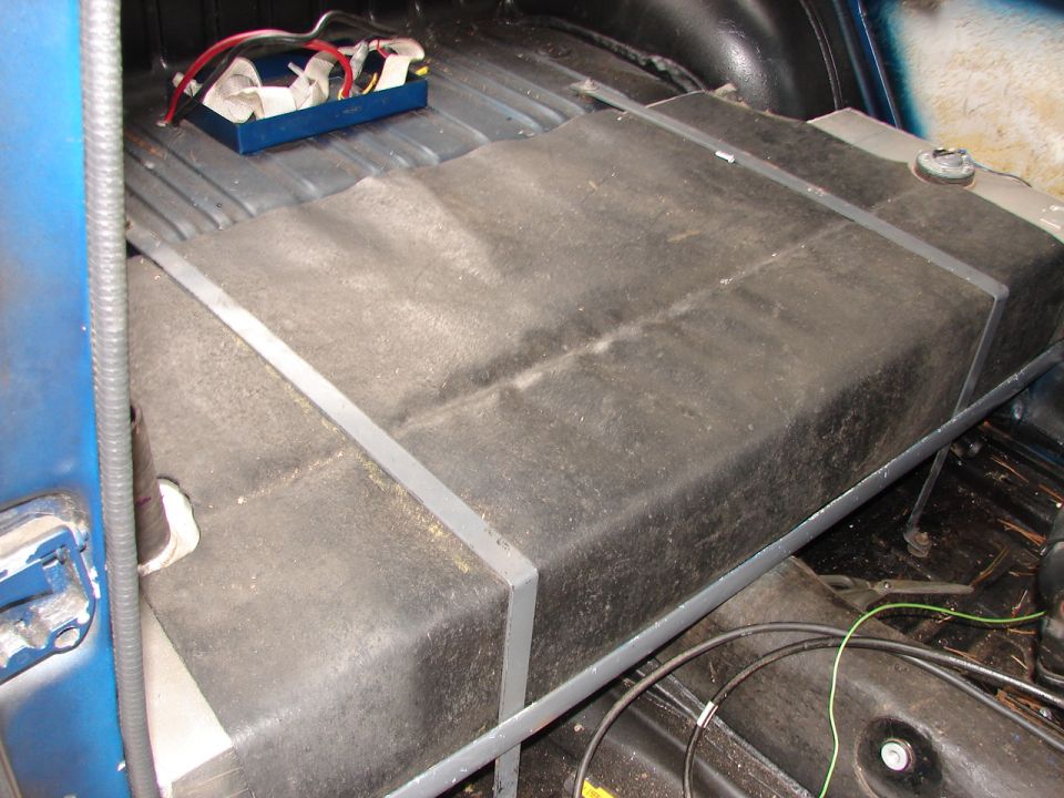 Interior view of a large fuel tank with wiring and a blue box
