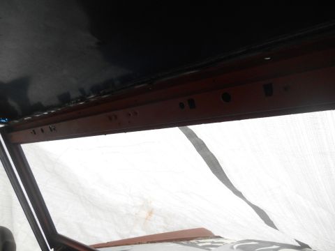 1972 Ford Bronco - View from inside a vehicle, showing the upper interior structure and a covered windshield.