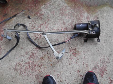 1972 Ford Bronco - A disassembled windshield wiper motor assembly lies on a concrete surface.