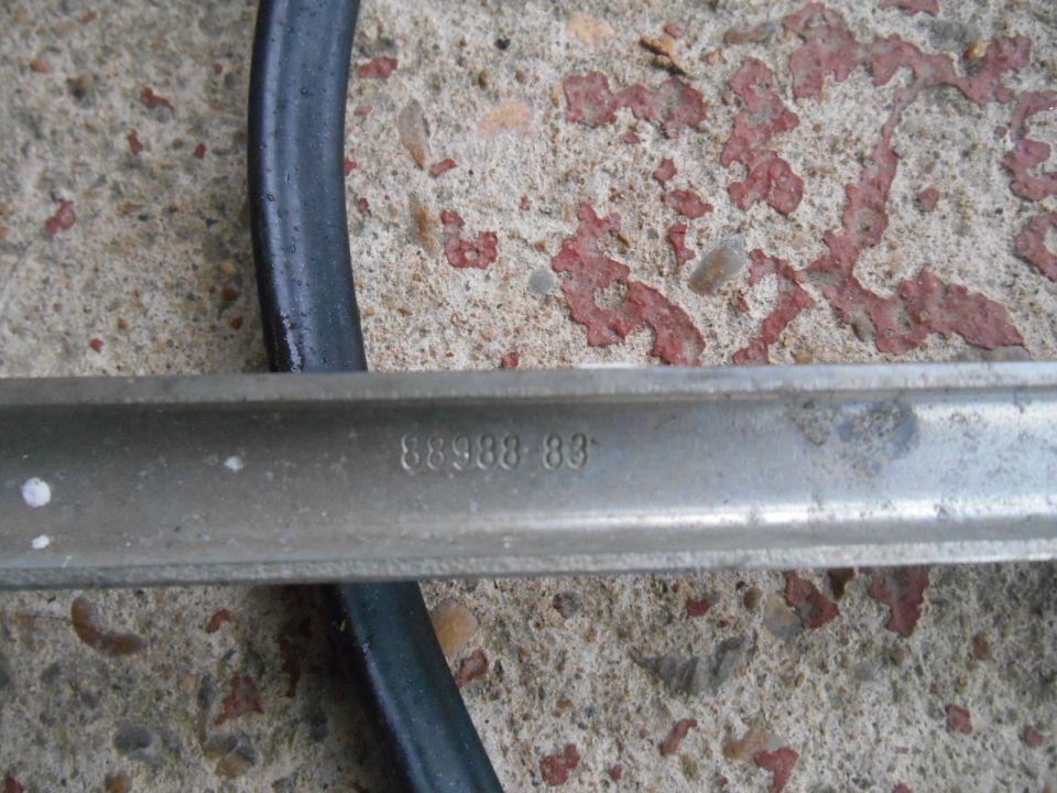 Part with stamped numbers 88988 83