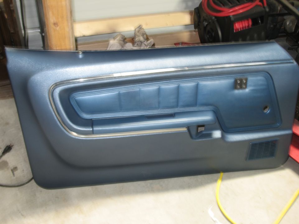 Blue door panel with chrome trim and textured insert