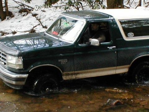1993 Ford Bronco - This 1993 Ford Bronco navigates through a shallow stream in a wooded area.