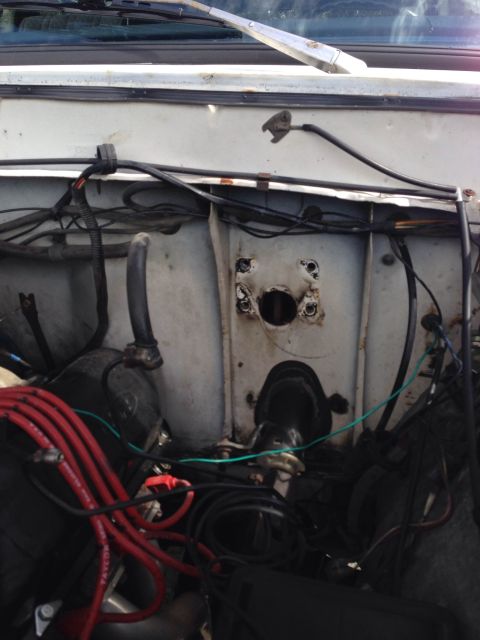 1979 Ford Bronco - The engine bay shows a complex network of wires and hoses, with some signs of wear and tear.