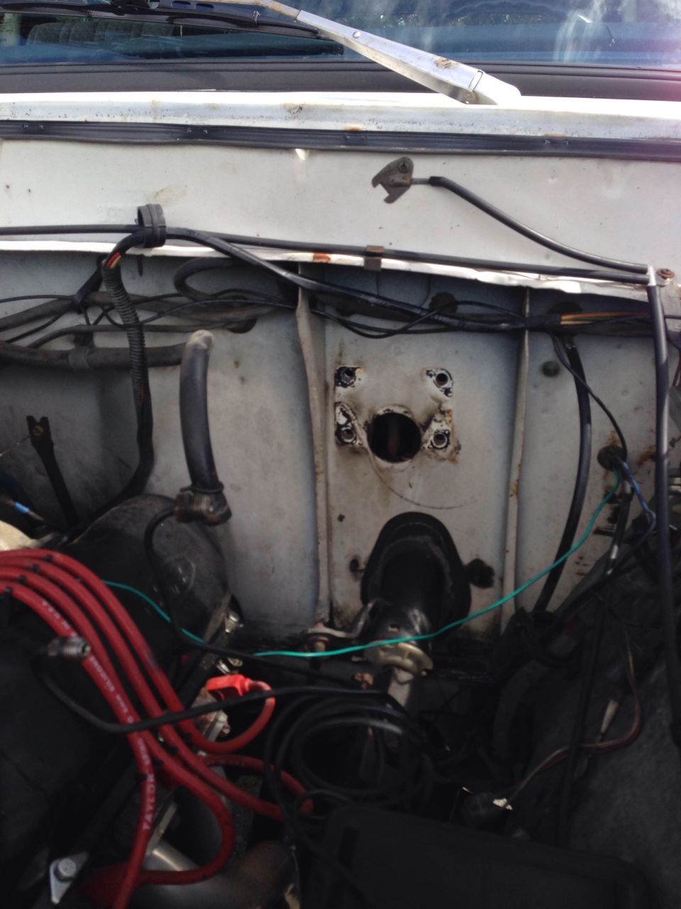 Close-up of the engine bay with lots of wires and hoses visible