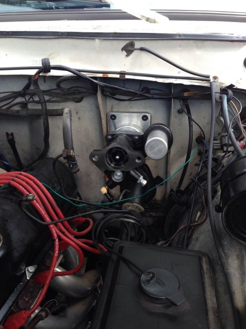 1979 Ford Bronco - Close-up view of a vehicle's engine bay, focusing on the brake master cylinder and associated components.