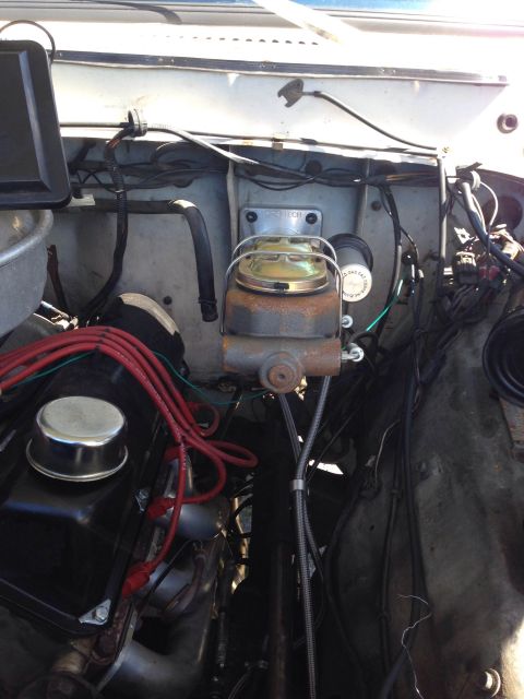 1979 Ford Bronco - Close-up view of an engine bay, focusing on the brake master cylinder and associated components.