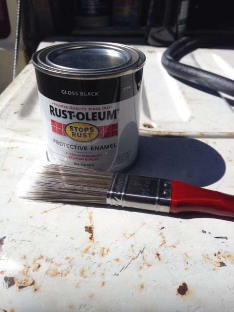 1979 Ford Bronco - Rust-Oleum paint can and paintbrush on a weathered surface.