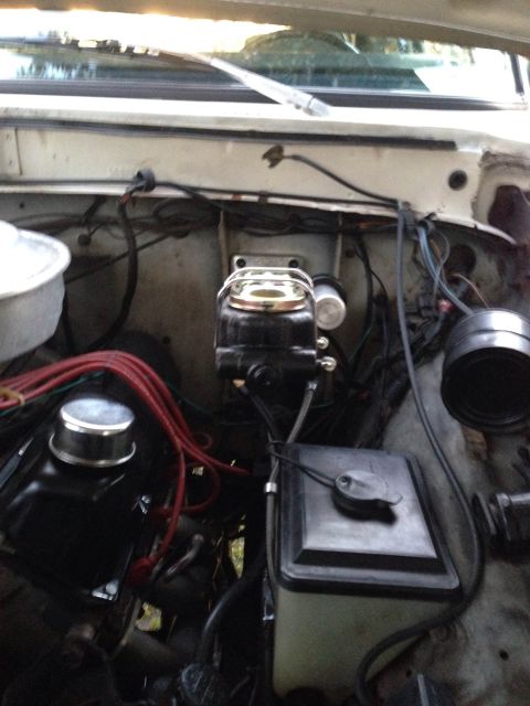 1979 Ford Bronco - The engine bay shows various components, including the brake master cylinder and fluid reservoir.