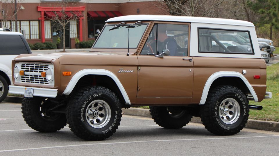 Brown 1979 Ford Bronco with white top, 3/4 front view