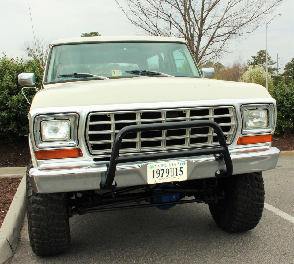 Front view of a white Ford Bronco, license plate reads 1979U15