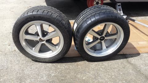 1976 Ford Ranchero - Two aftermarket wheels and tires are shown, one with an SVT center cap, with a jack in the background.