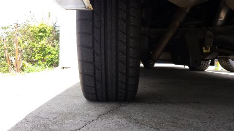 1976 Ford Ranchero - Undercarriage view showing the rear tire and suspension system of a vehicle.
