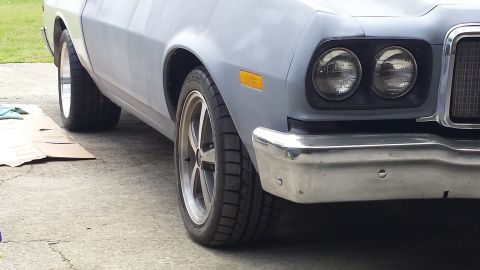 1976 Ford Ranchero - The front passenger side of a 1976 Ford Ranchero shows its chrome bumper and dual headlights.