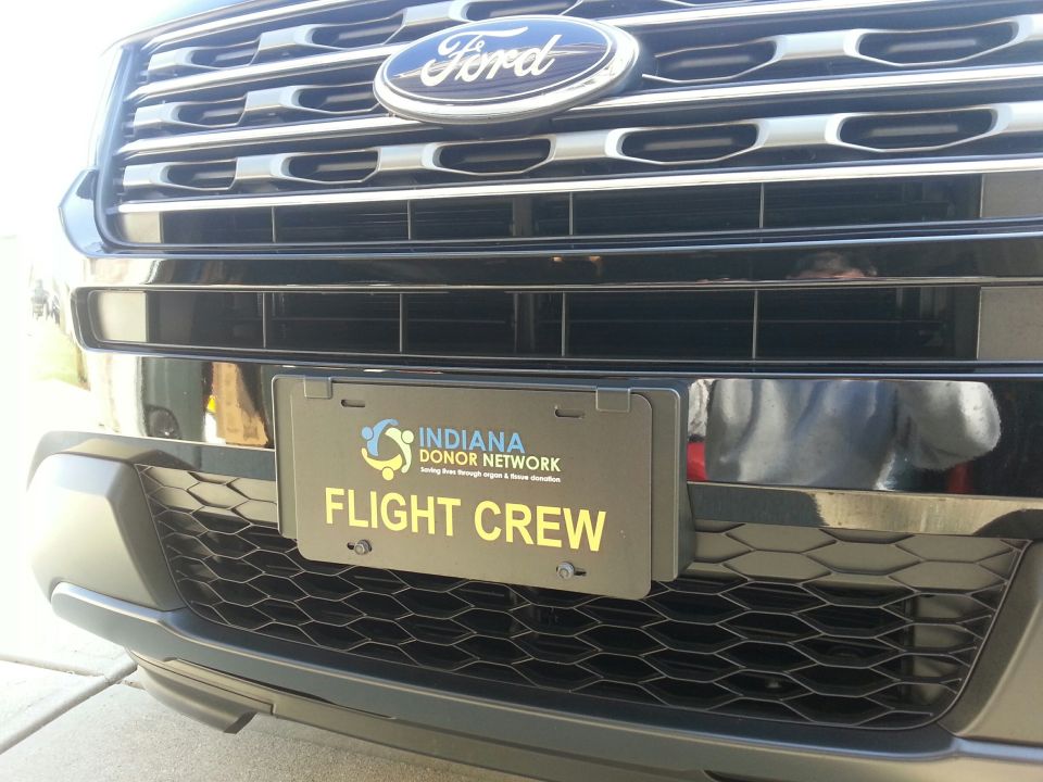 Front view of a black Ford Explorer with a license plate for Indiana Donor Network Flight Crew.