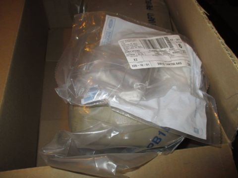2004 Ford Crown Victoria - Shipping box containing several automotive parts in plastic packaging.
