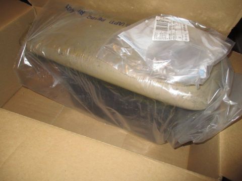 2004 Ford Crown Victoria - A car part is shown inside a cardboard box, wrapped in protective plastic packaging.