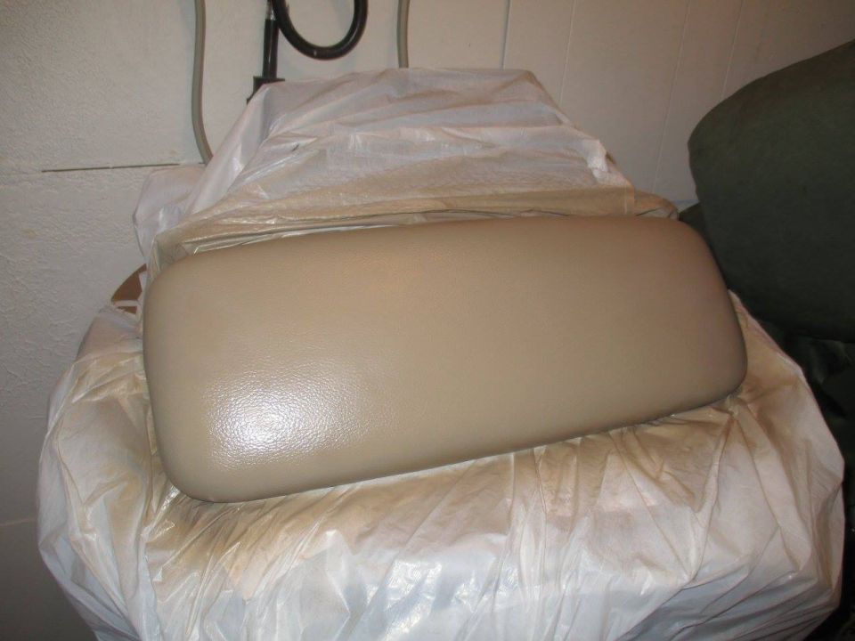 Tan car armrest covered in plastic wrap