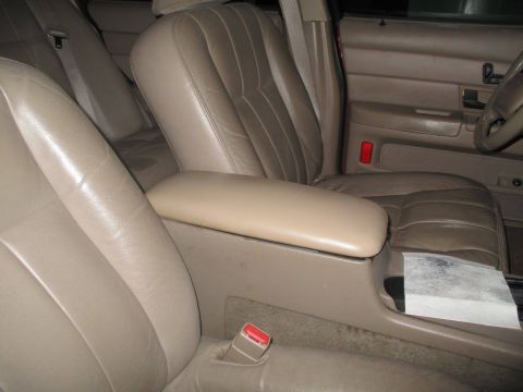 2004 Ford Crown Victoria - Interior view of a tan leather car, showing the front seats and center console.