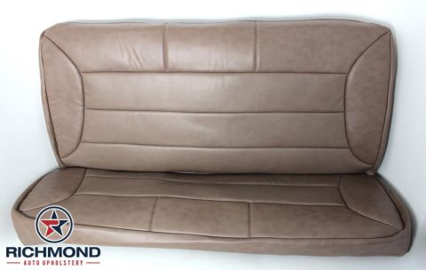 1996 Ford Bronco - This is a close-up of a tan car seat, likely a replacement cover, with visible stitching patterns.