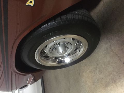 1971 Dodge Dart - Close-up of the wheel and fender of a brown 1971 Dodge Dart, a gold 'A' badge.