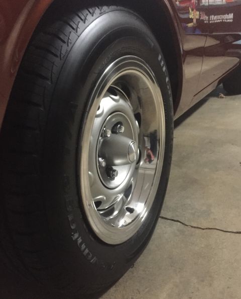 1971 Dodge Dart - A close-up shot focuses on the wheel and tire of a vehicle, with a reflection visible on the chrome rim.