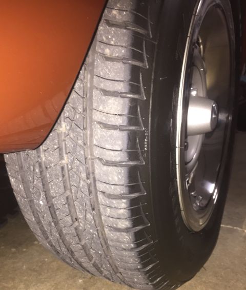 1971 Dodge Dart - Close-up of a tire and wheel on an orange vehicle.