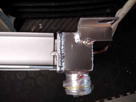 1992 Ford Bronco - This is a close-up view of a radiator part, showing its construction and a protected fitting.