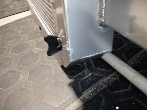 1992 Ford Bronco - Close-up of a radiator part, showing a black knob and welded seams. The registry claims it is from a 1992 Ford Bronco.