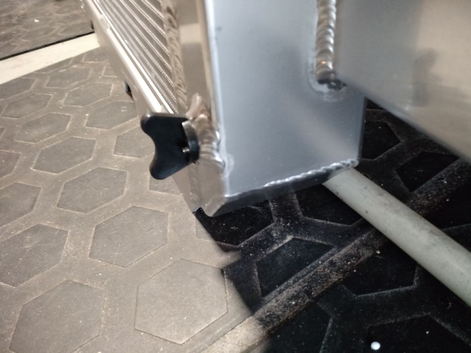 Radiator with black knob and visible welds