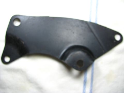 1969 Ford Torino - A black metal bracket with multiple holes is shown against a white and blue striped background.