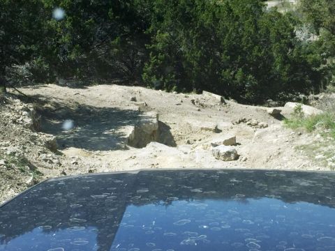 1996 Ford Bronco - Navigating a challenging off-road path with a vehicle.
