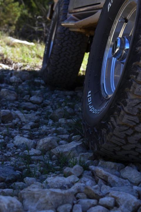 1996 Ford Bronco - Two vehicles with off-road tires are parked on a rocky surface. The tires are BFGoodrich All-Terrain T/A.
