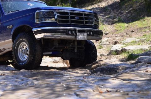 1996 Ford Bronco - This 1996 Ford Bronco navigates a rocky, wet trail, its off-road capabilities.