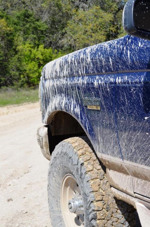 1996 Ford Bronco - This blue truck is covered in mud after an off-roading adventure.