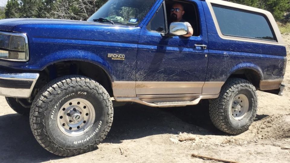 1996 Ford Bronco with BFGoodrich All-Terrain T/A tires on dirt road