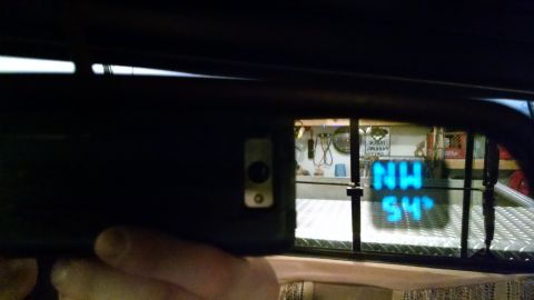 1979 Ford F-150 - Digital display in a vehicle's rearview mirror shows 'NW' and '54'.