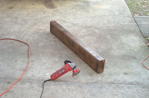 1995 Ford Bronco - A metal beam and an angle grinder are on a concrete surface.