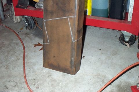 1995 Ford Bronco - A metal post with chalk lines indicating cuts or welds, situated in a workshop environment.