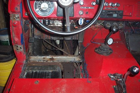 1974 Ford Bronco - The interior of a 1974 Ford Bronco is shown, with visible rust and unfinished bodywork.