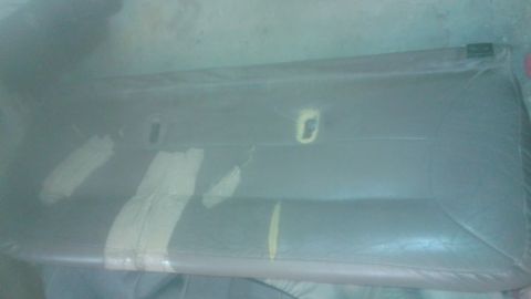 1996 Ford Bronco - Close-up of an interior door panel, possibly undergoing cleaning or repair.